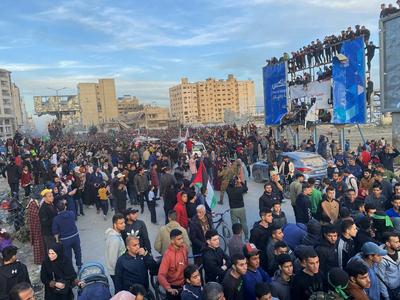 Palestinians gather near the site of the handover of the Israeli hostages to the International Committee of the Red Cross (ICRC)-stock-photo