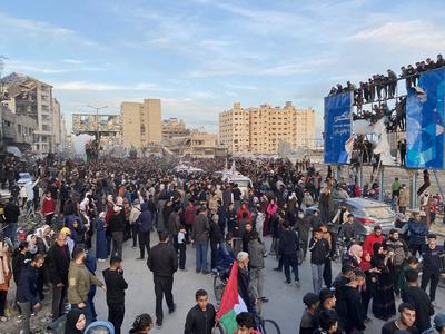 Palestinians gather near the site of the handover of the Israeli hostages to the International Committee of the Red Cross (ICRC)-stock-photo