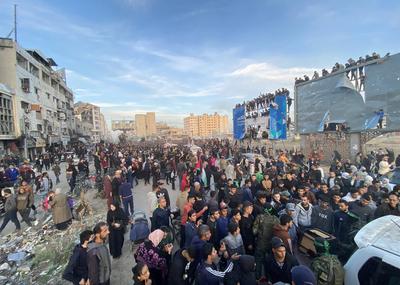 Palestinians gather near the site of the handover of the Israeli hostages to the International Committee of the Red Cross (ICRC)-stock-photo