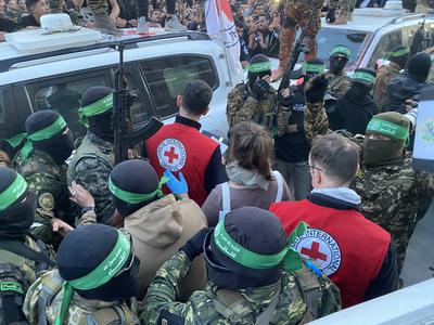 Palestinians gather near the site of the handover of the Israeli hostages to the International Committee of the Red Cross (ICRC)-stock-photo