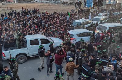 Palestinians gather near the site of the handover of the Israeli hostages to the International Committee of the Red Cross (ICRC) during the hostage-prisoner exchange operation in Saraya Square in western Gaza-stock-photo
