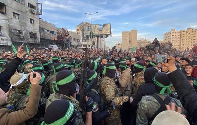 Palestinians gather near the site of the handover of the Israeli hostages to the International Committee of the Red Cross (ICRC)-stock-photo