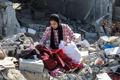 Displaced Palestinians continue to return their houses past heavily damaged and partially collapsed buildings after the ceasefire and hostage-prisoner swap deal between Hamas and Israel at Bureij-stock-photo