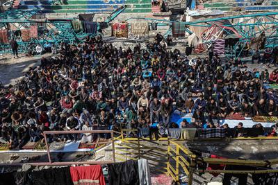 Palestinians perform Friday prayers at the Al-Bureij Services Club stadium, which was destroyed by Israeli airstrikes on the Al-Burei-stock-photo