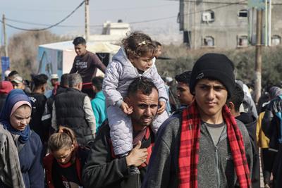 Palestinians wait to be allowed to return to their homes in northern Gaza after they were displaced to the south at Israel's order during the war, amid a ceasefire between Israel and Hamas, in the central Gaza-stock-foto