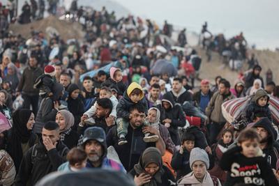 Palestinians, who were displaced to the south at Israel's order during the war, make their way back to their homes in northern Gaza, amid a ceasefire between Israel and Hamas, in the central Gaza Strip-stock-foto