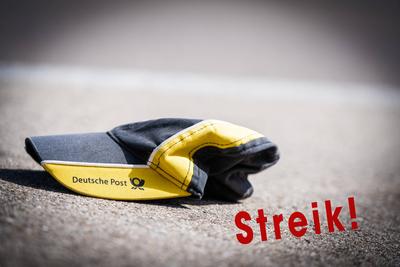 18 February 2023: Cap of an employee of Deutsche Post on the street with the writing: Strike. Symbol image strike of the-stock-photo