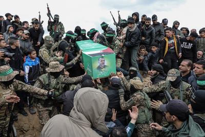 Members of the al-Qassam Brigades of Hamas attend the funeral ceremony of Merwan Isa a commander of the al-Qassam Brigades, who was killed during an Israeli attack, at Bureij refugee camp in central of Gaza Strip-stock-photo