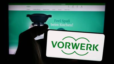 Person holding smartphone with logo of German household appliances company Vorwerk SE Co. KG. Stuttgart, Germany - 08-07-stock-foto