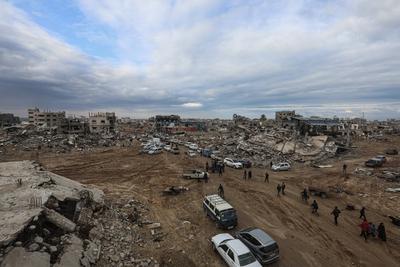 Palestinians inspect the destruction after the Israeli army withdrew from the Netzarim corridor, as part of a ceasefire agreement with Hamas in Gaza City-stock-photo