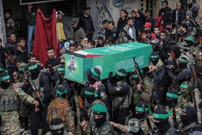 Members of the al-Qassam Brigades of Hamas attend the funeral ceremony of Merwan Isa a commander of the al-Qassam Brigades, who was killed during an Israeli attack, at Bureij refugee camp in central of Gaza Strip-stock-photo
