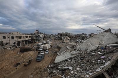 Palestinians inspect the destruction after the Israeli army withdrew from the Netzarim corridor, as part of a ceasefire agreement with Hamas in Gaza City-stock-photo
