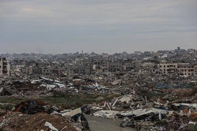 Palestinians inspect the destruction after the Israeli army withdrew from the Netzarim corridor, as part of a ceasefire agreement with Hamas in Gaza City-stock-photo