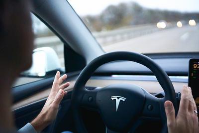Bavaria, Germany - November 22, 2024: Symbolic image for autonomous driving with a Tesla. The driver of a Tesla electric-stock-foto
