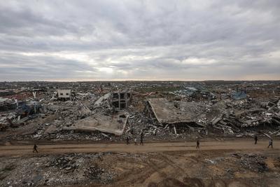 Palestinians inspect the destruction after the Israeli army withdrew from the Netzarim corridor, as part of a ceasefire agreement with Hamas in Gaza City-stock-photo