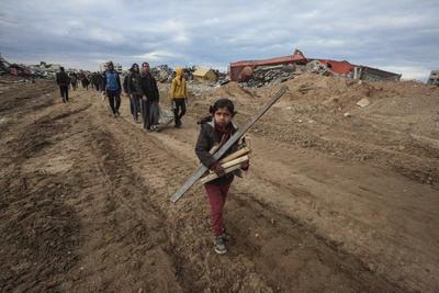 Palestinians inspect the destruction after the Israeli army withdrew from the Netzarim corridor, as part of a ceasefire agreement with Hamas in Gaza City-stock-photo