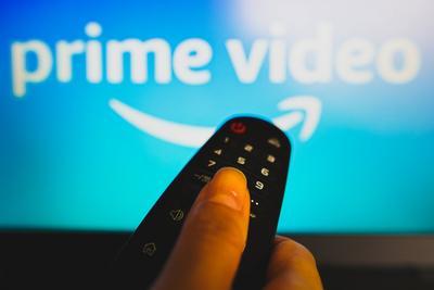 May 10, 2022, Brazil. In this photo illustration a close-up of a hand holding a TV remote control seen in front of the A-stock-foto