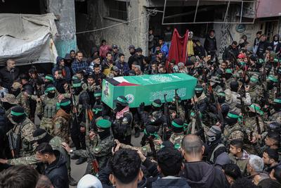 Members of the al-Qassam Brigades of Hamas attend the funeral ceremony of Merwan Isa a commander of the al-Qassam Brigades, who was killed during an Israeli attack, at Bureij refugee camp in central of Gaza Strip-stock-photo