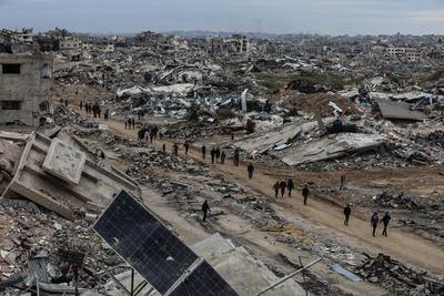 Palestinians inspect the destruction after the Israeli army withdrew from the Netzarim corridor, as part of a ceasefire agreement with Hamas in Gaza City-stock-photo