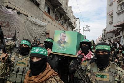 Members of the al-Qassam Brigades of Hamas attend the funeral ceremony of Merwan Isa a commander of the al-Qassam Brigades, who was killed during an Israeli attack, at Bureij refugee camp in central of Gaza Strip-stock-photo