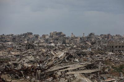 Palestinians inspect the destruction after the Israeli army withdrew from the Netzarim corridor, as part of a ceasefire agreement with Hamas in Gaza City-stock-photo
