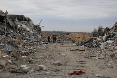 Palestinians inspect the damage to the TIKA towers after the Israeli occupation army withdrew from the Juhr al-Dik area, as part of a ceasefire agreement with Hamas in Gaza City-stock-photo