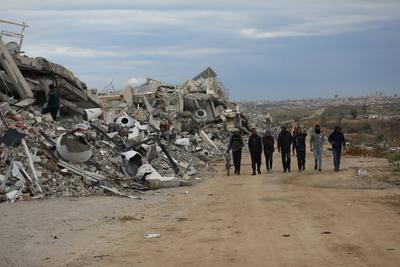 Palestinians inspect the damage to the TIKA towers after the Israeli occupation army withdrew from the Juhr al-Dik area, as part of a ceasefire agreement with Hamas in Gaza City-stock-photo