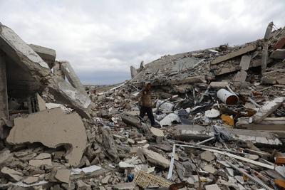 Palestinians inspect the damage to the TIKA towers after the Israeli occupation army withdrew from the Juhr al-Dik area, as part of a ceasefire agreement with Hamas in Gaza City-stock-photo