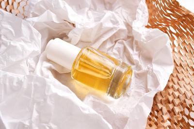 Bottle with yellow serum on paper from the parcel. Bottle with yellow serum on paper from the parcel. High quality photo-stock-photo