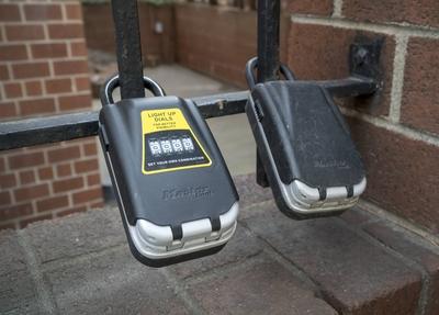 Apartment sharing lockboxes in New York Lockboxes attached to a gate outside an apartment building i-stock-foto