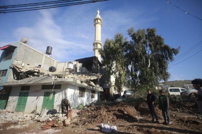 Residents inspect the damage done as Israeli troops withdraw from Al Farea refugee camp following a four-day campaign, near the West Bank city of Tubas-stock-photo