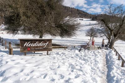 Maienfeld, GR, Switzerland - January 20, 2019: Maienfeld tourist attraction Heidi village in winter with sign and sculpt-stock-photo