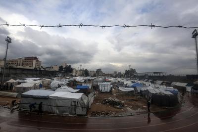Displaced Palestinians take shelter in tents set up at the Yarmouk stadium in Gaza City-stock-photo