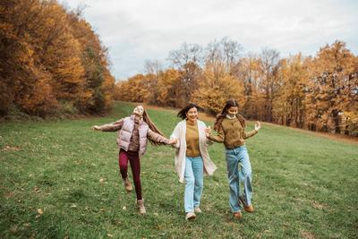 Grandmother spending time with granddaugters, walking in the nature. Multigenerational family concept.-stock-photo