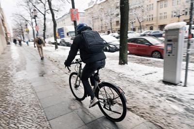 2025-02-14,Berlin,Winterliche Impression,Person mit Fahrrad unterwegs auf dem Gehweg *** 2025 02 14,Berlin,Winter impres-stock-photo
