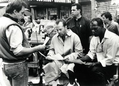 Movie director John McTiernan, Bruce Willis, and Samuel L. Jackson on the set of the movie Die Hard, 1988 PUBLICATIONxNO-stock-photo