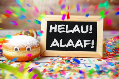 6 February 2024: Helau and Alaaf! Fool s call lettering on a carnival sign with doughnuts, streamers and confetti PHOTOM-stock-foto