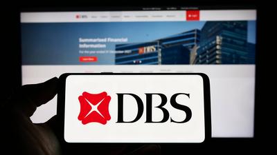 Person holding cellphone with logo of Singaporean financial company DBS Bank Limited on screen. Stuttgart, Germany - 03--stock-foto