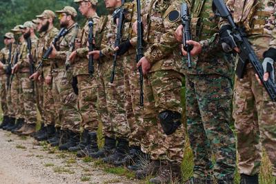Soldier fighters standing together with guns. Group portrait of US army elite members, private military company servicem-stock-foto