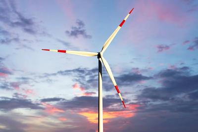 Bavaria, Germany - February 11, 2025: FOTOMONTAGE, a wind turbine towers into the evening sky and shows the power of nat-stock-foto