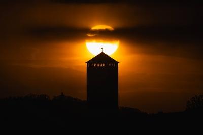 Sonnenuntergang Die Sonne geht unter hinter dem Wasserturm in Wei?kirchen, einem Stadtteil von Oberursel, bei Frankfurt-stock-foto