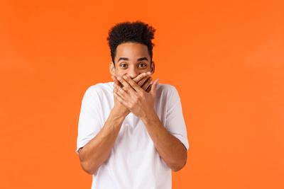 Guy made funny prank trying hold laugh. Hilarious and amused african-american male in white t-shirt, giggle cover mouth-stock-photo