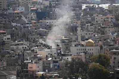 An Israeli military bulldozer demolishes Palestinian homes in the Nur Shams refugee camp east of Tulkarm-stock-photo