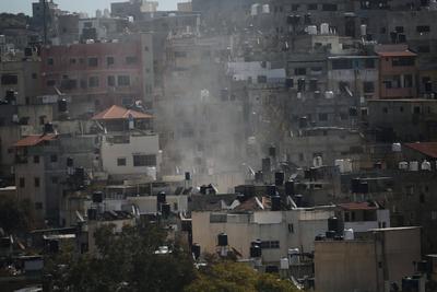 An Israeli military bulldozer demolishes Palestinian homes in the Nur Shams refugee camp east of Tulkarm-stock-photo