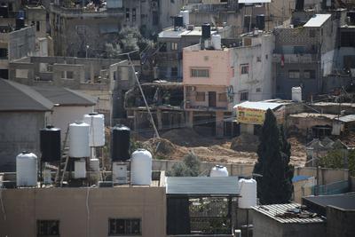 An Israeli military bulldozer demolishes Palestinian homes in the Nur Shams refugee camp east of Tulkarm-stock-photo