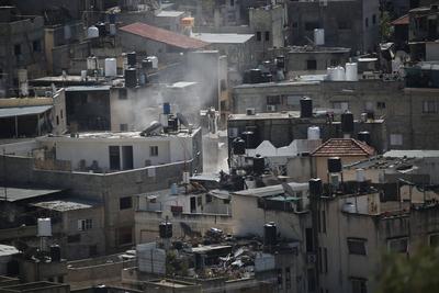 An Israeli military bulldozer demolishes Palestinian homes in the Nur Shams refugee camp east of Tulkarm-stock-photo