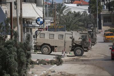 An Israeli military bulldozer demolishes Palestinian homes in the Nur Shams refugee camp east of Tulkarm-stock-photo
