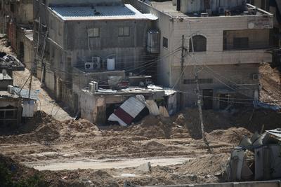 An Israeli military bulldozer demolishes Palestinian homes in the Nur Shams refugee camp east of Tulkarm-stock-photo