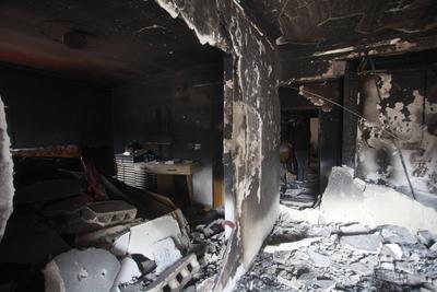 Palestinians inspect an apartment that was targeted by an Israeli air strike in the eastern neighborhood of Jenin-stock-photo