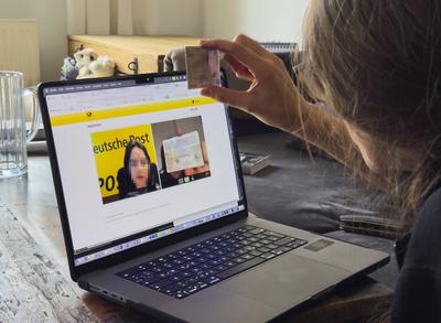 Woman is identifying herself in a PostIdent procedure on a laptop in Marktoberdorf, Germany, January 8, 2024.-stock-foto